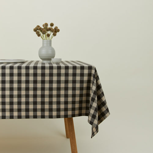 Essential Gingham tablecloth in grey/black on a table with florals