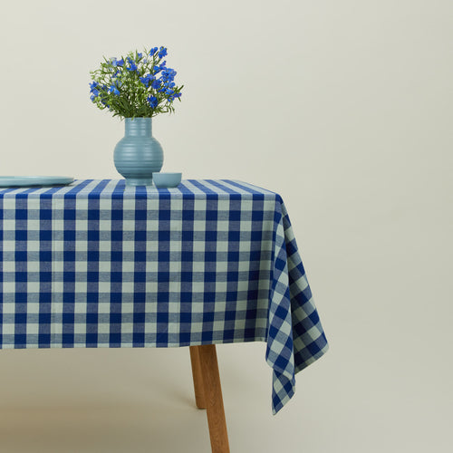 Essential Gingham tablecloth in sky/blue on a table with florals